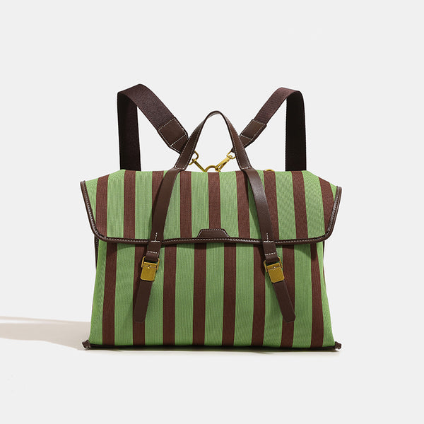 Structured striped canvas convertible satchel bag with leather-look trim, gold-tone buckle hardware, and backpack straps