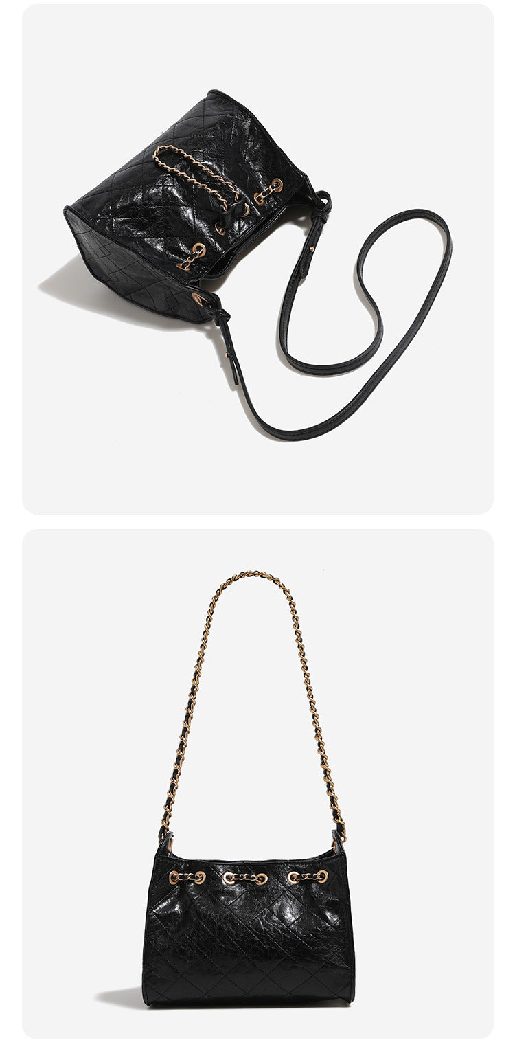 Glossy diamond-quilted drawstring bucket bag with gold-tone chain strap and eyelet hardware, detail view 15
