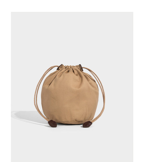 Chevron-woven bucket tote bag with braided shoulder straps and matching drawstring pouch, detail view 17