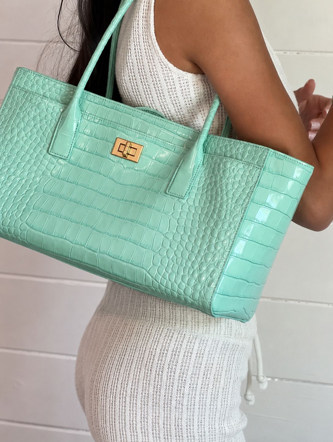 Structured glossy crocodile-embossed tote bag with gold-tone turn-lock closure and double top handles, detail view 17