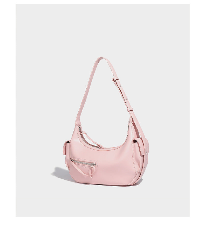 Smooth leather-look crescent shoulder bag with front zip pocket, side flap pockets, adjustable strap, and silver-tone, detail