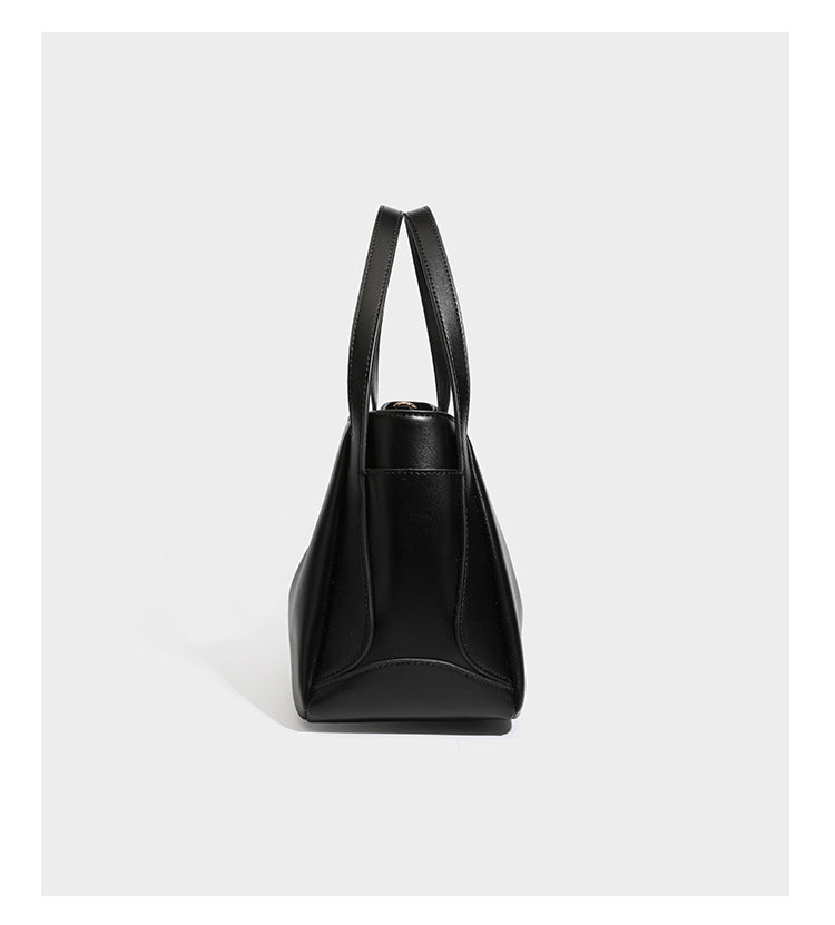 Structured glossy leather-look tote shoulder bag with dual top handles, detachable crossbody strap, side pockets, and, detail
