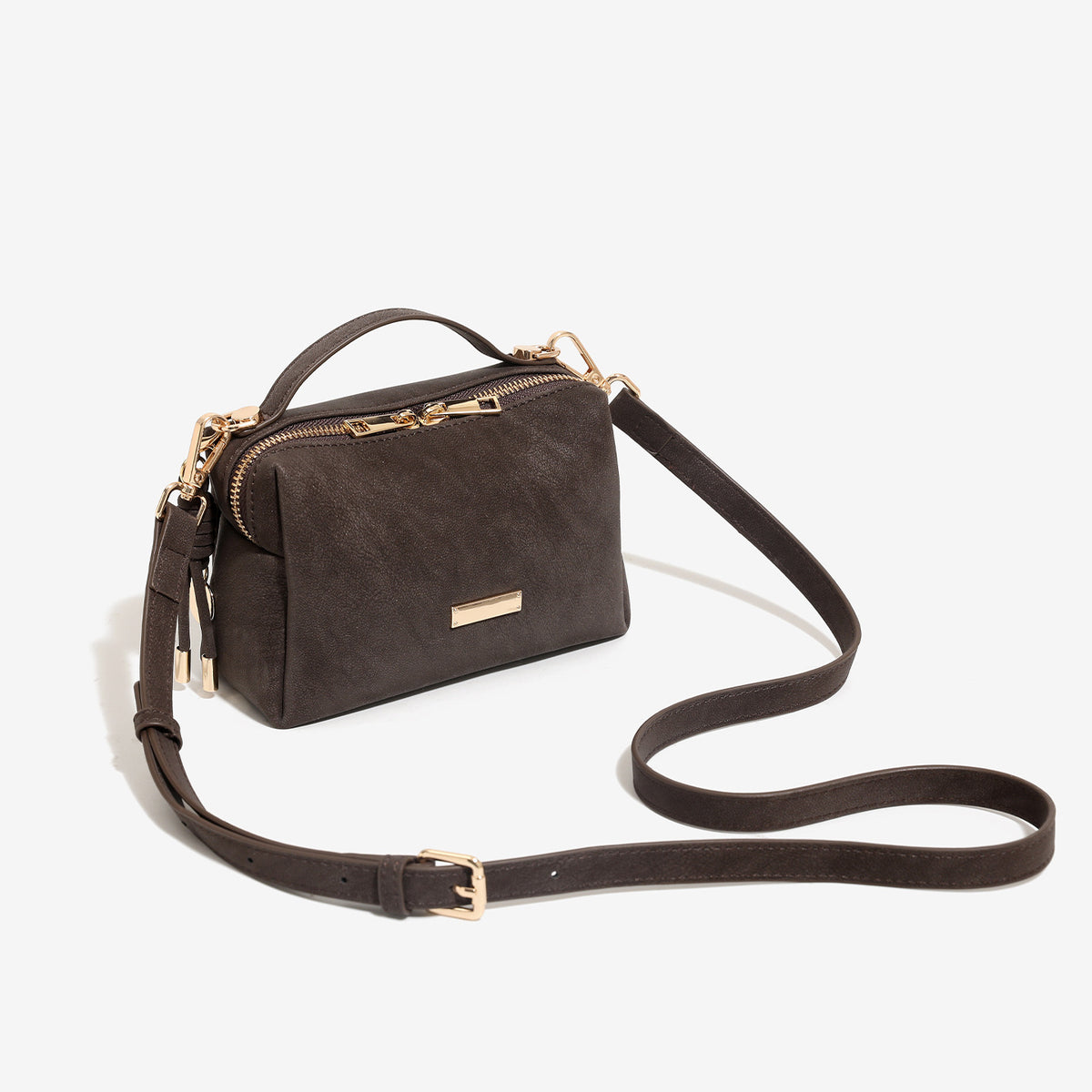 Mini boxy top-handle crossbody bag in matte textured leather-look finish with gold-tone zipper hardware and side tassel