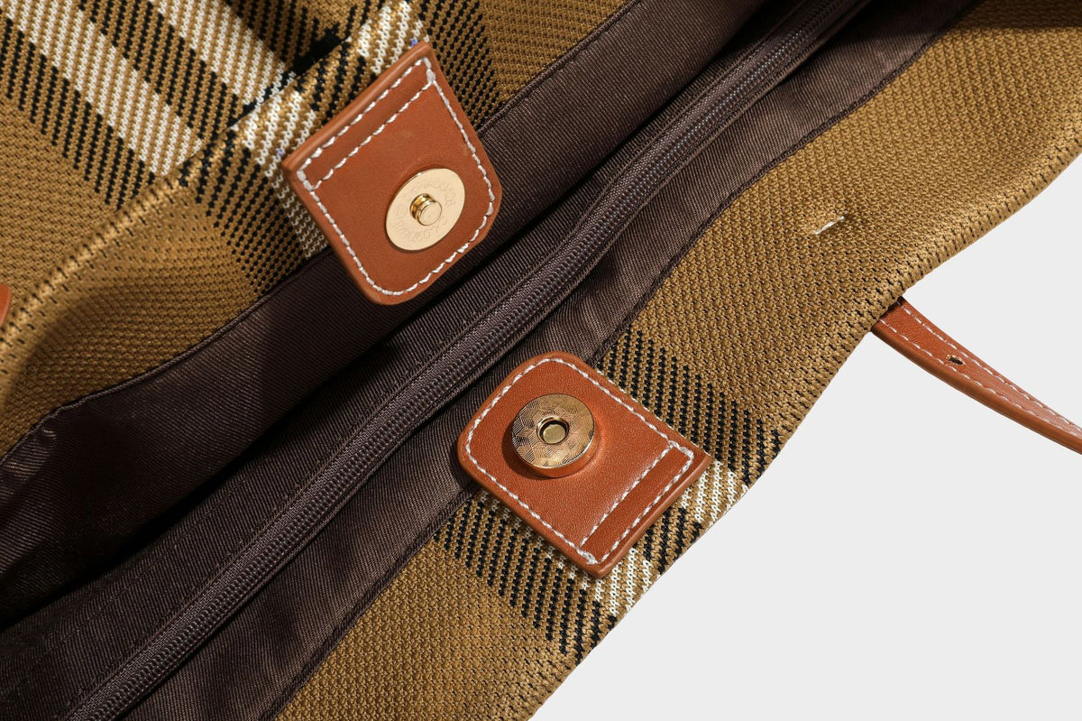 Large structured plaid check tote bag with smooth tan leather-look shoulder straps, attached front zip pouch, and gold-tone