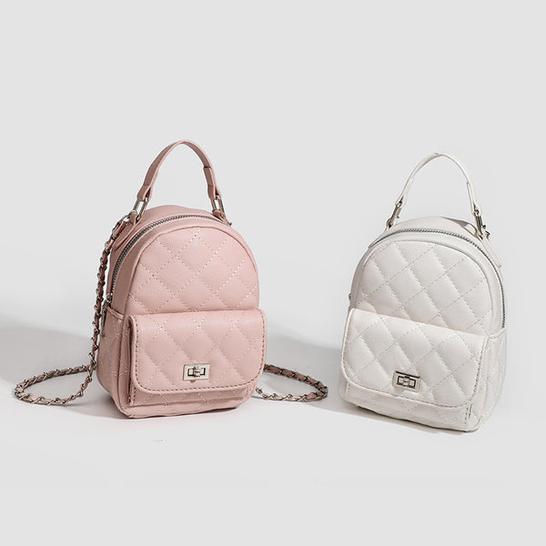 Compact diamond-quilted mini backpack handbag with silver-tone chain straps and turn-lock front pocket, detail view 2