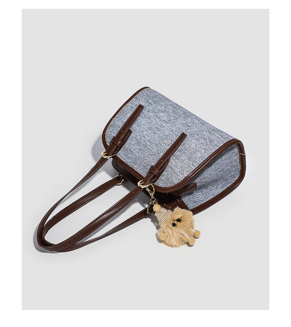 Small structured grey fabric shoulder bag with brown leather-look trim, gold-tone hardware, dual top handles, and detachable