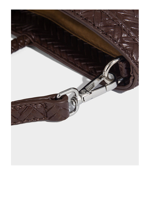 Structured chevron woven leather-look tote bag with braided top handles, gold feather charm, and adjustable shoulder strap