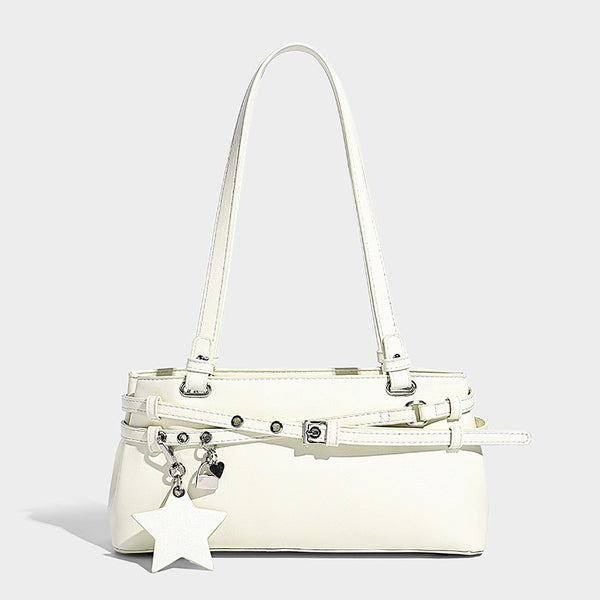 Structured glossy leather-look shoulder bag with wraparound belt straps, silver-tone hardware, and dangling star charm