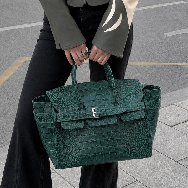 Large structured tote satchel with glossy crocodile-embossed leather-look finish, dual top handles, and metal buckle flap