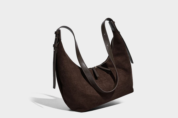 Slouchy crescent hobo shoulder bag in dark chocolate matte suede-look finish with adjustable strap and twin-pull top zip