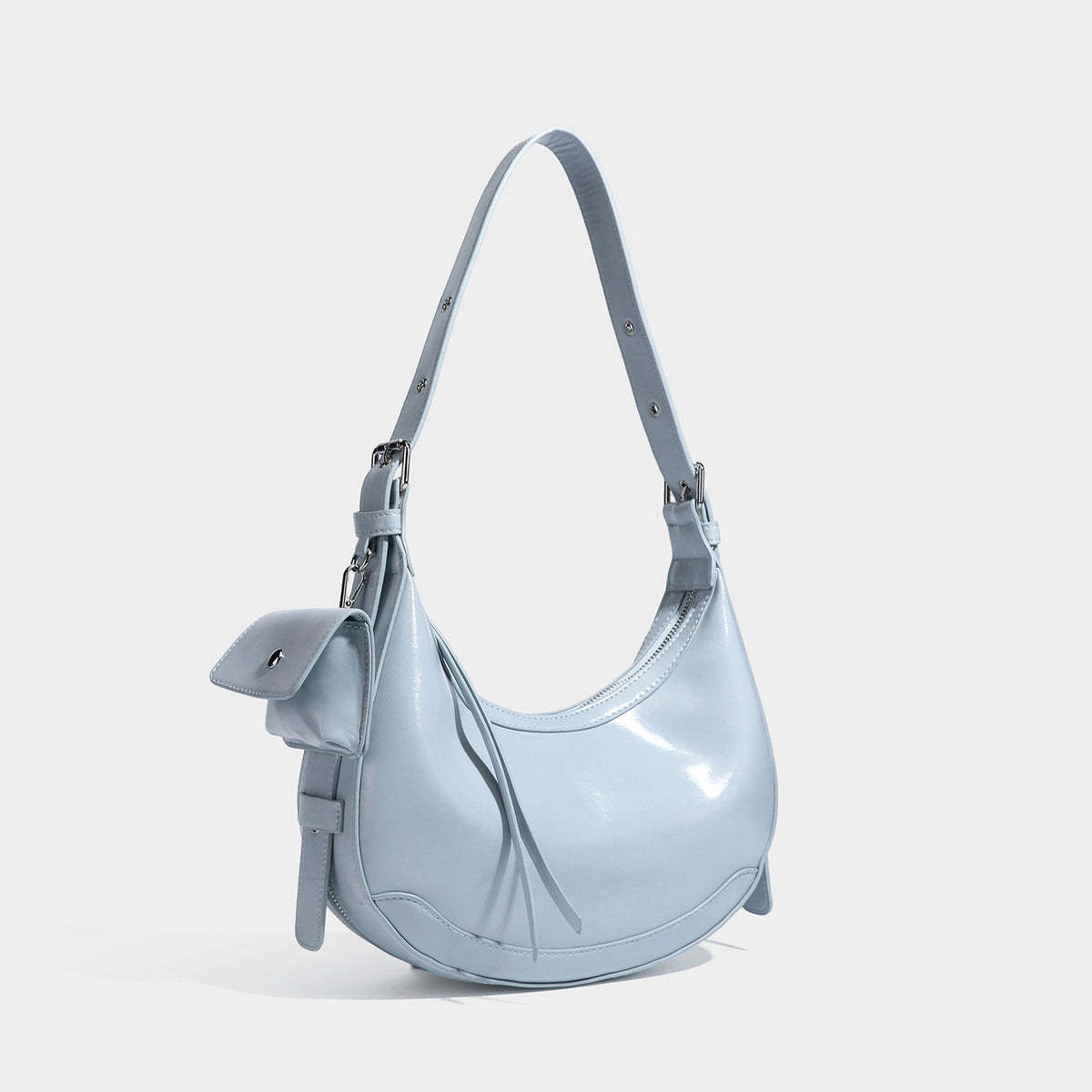 Glossy leather-look crescent hobo shoulder bag with dark contrast trim, silver-tone hardware, and attached mini flap pouch