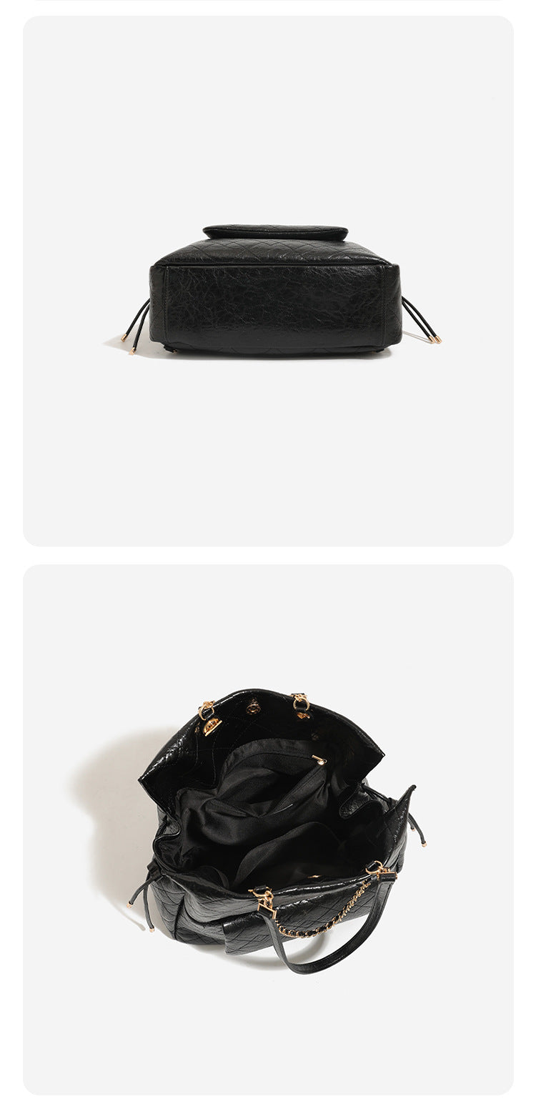 Large quilted leather-look drawstring backpack handbag with gold-tone chain handles and front flap pocket, detail view 10