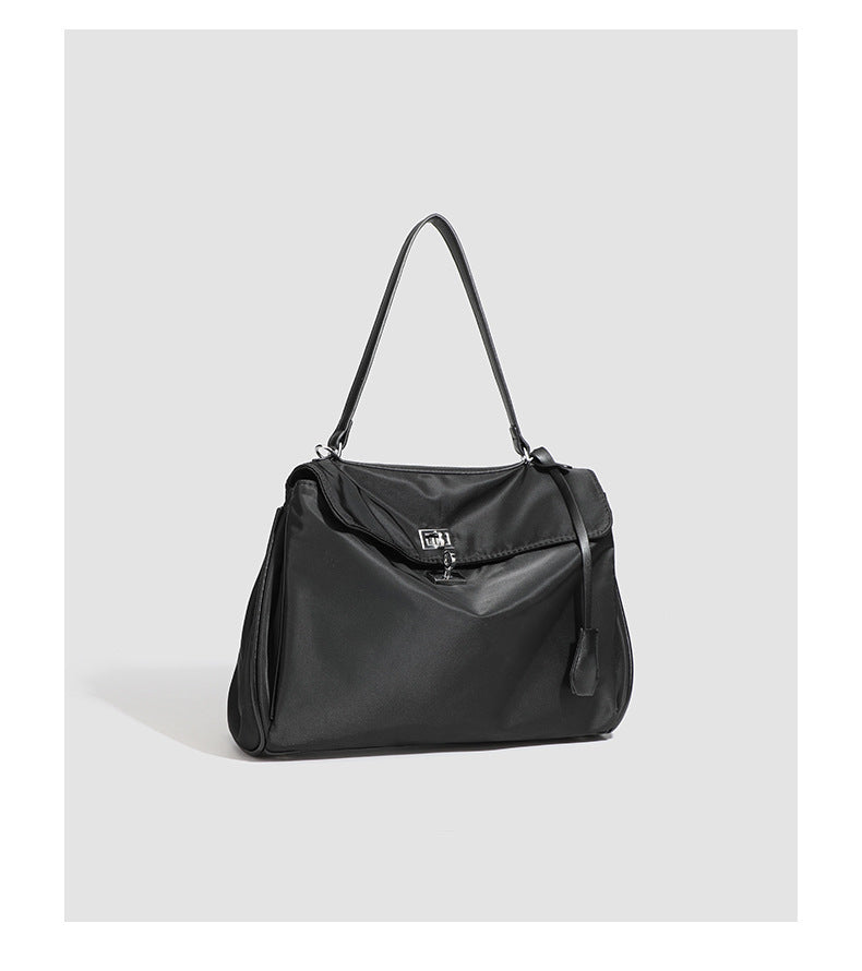 Structured black leather-look flap satchel bag with silver turn-lock hardware and top handle, detail view 27