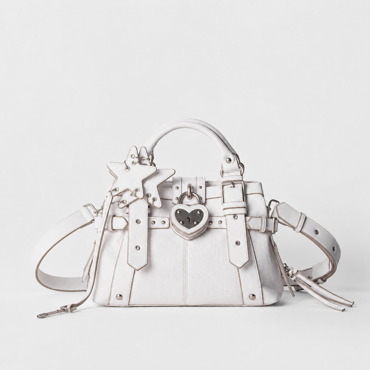 Structured satchel bag with heart-shaped padlock hardware, rivet studs, star charm, and twin top handles, detail view 7