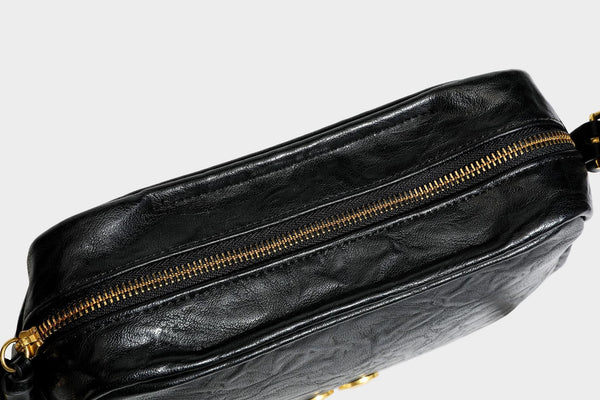 Compact black crinkled leather-look baguette shoulder bag with gold-tone arch hardware and adjustable strap, detail view 35