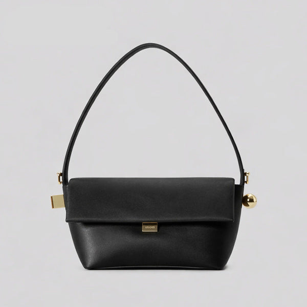 Structured trapezoid flap shoulder bag in red leather-look finish with gold-tone turn-lock clasp, sphere accent, and curved