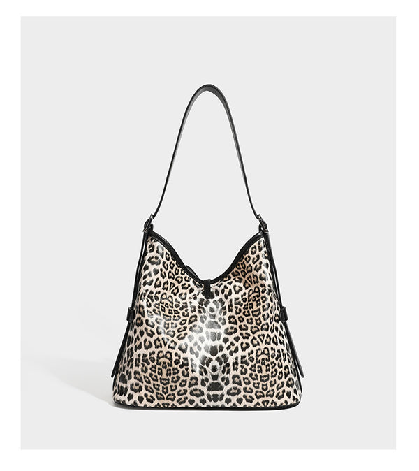 Slouchy leopard print shoulder hobo bag with black leather-look trim, tie-top closure, and single long strap, detail view 9