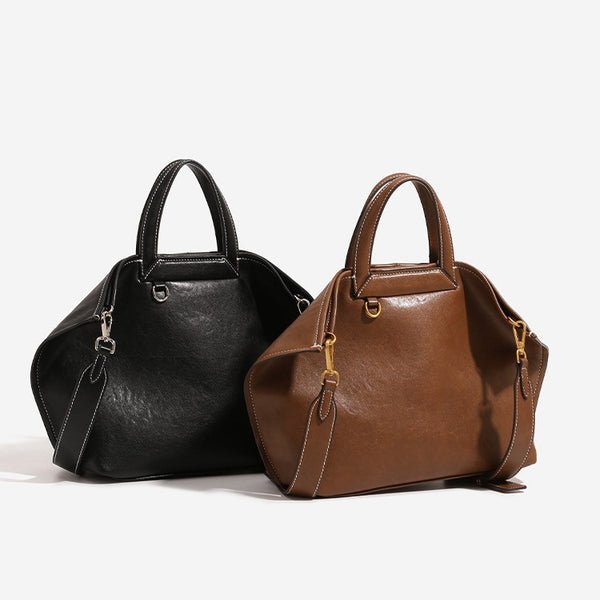 Structured cognac brown leather-look tote bag with fold-ear side panels, top handles, gold-tone hardware, and detachable