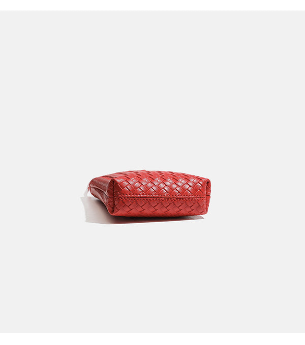 Compact woven leather-look bucket crossbody pouch with toggle closure and long fixed strap, detail view 11