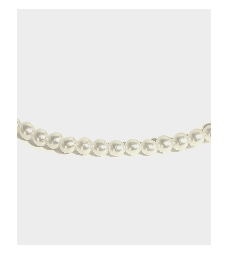 Small pearl-beaded lattice drawstring bucket bag with beaded shoulder strap and ribbon closure, detail view 14