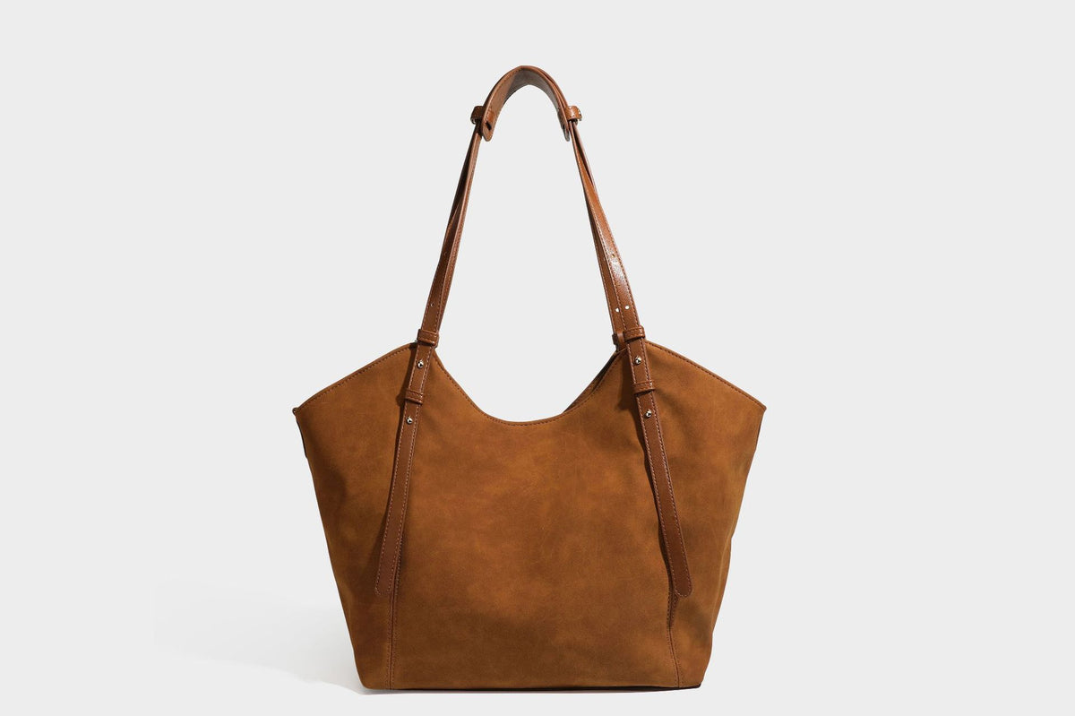 Oversized suede-finish tote shoulder bag in caramel brown with slim leather-look straps and gold-tone logo hardware, detail