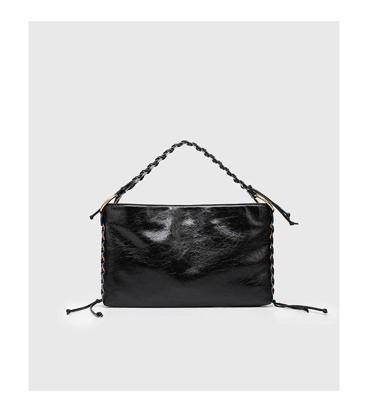 Large slouchy hobo shoulder bag with braided top handle, gold-tone O-ring hardware, and lace-up side cord detailing in