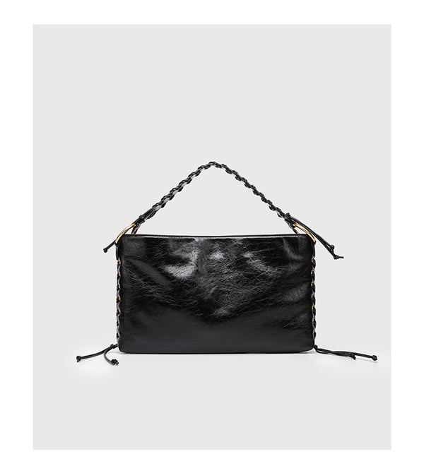 Large slouchy hobo shoulder bag with braided top handle, gold-tone O-ring hardware, and lace-up side cord detailing in