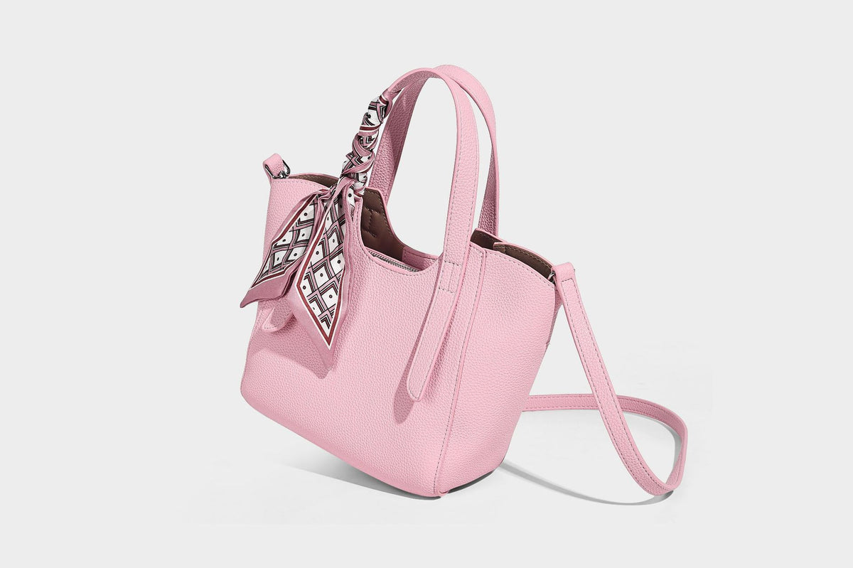 Structured pebbled leather-look tote bag with detachable scarf tie, dual top handles, and adjustable crossbody strap, detail