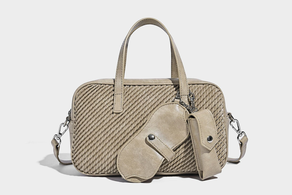 Structured woven-texture front top-handle handbag with zip closure, dual handles, detachable shoulder strap, and matching