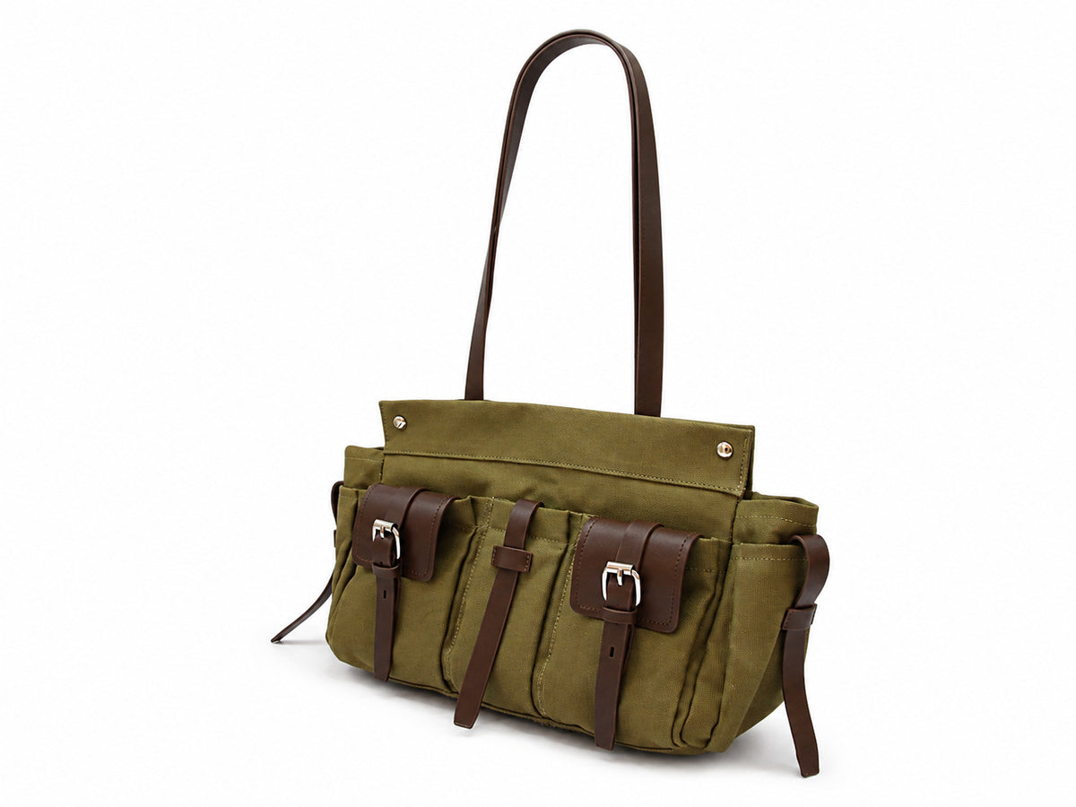 Large olive canvas shoulder tote bag with multiple front buckle-strap pockets and dark brown leather-look trim, detail view 6