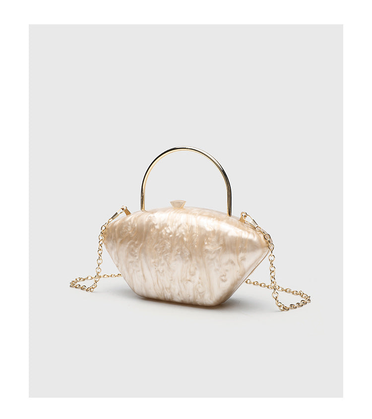 Shell-shaped pearlescent top-handle clutch bag with arched gold-tone metal handle and gold chain strap, detail view 16