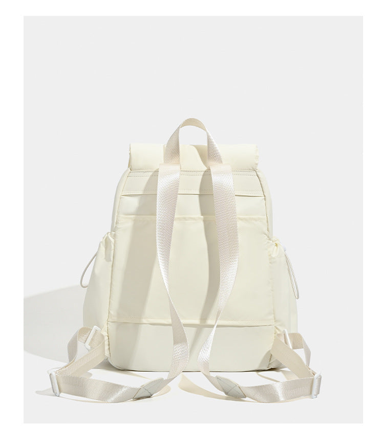 Soft matte nylon flap backpack with front zip pocket and side drawcord pockets, detail view 12