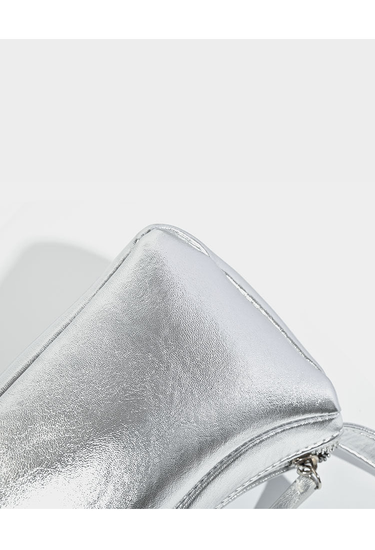 Compact curved silver metallic shoulder bag with top zip closure and slim single strap, detail view 10