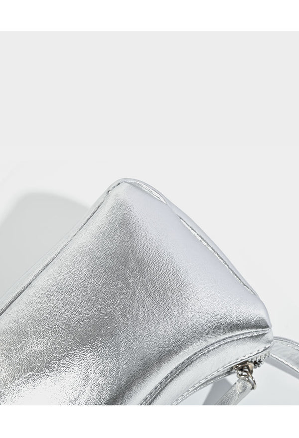 Compact curved silver metallic shoulder bag with top zip closure and slim single strap, detail view 10