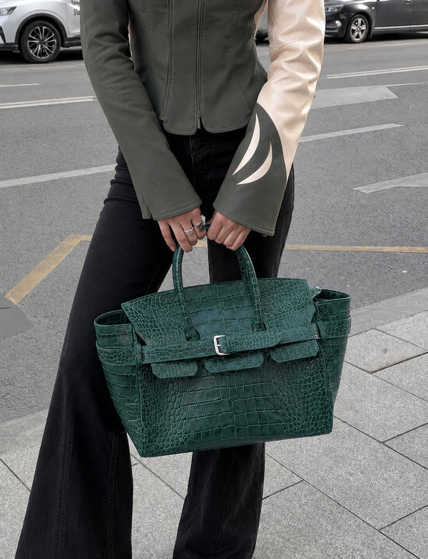 Large structured tote satchel with glossy crocodile-embossed leather-look finish, dual top handles, and metal buckle flap