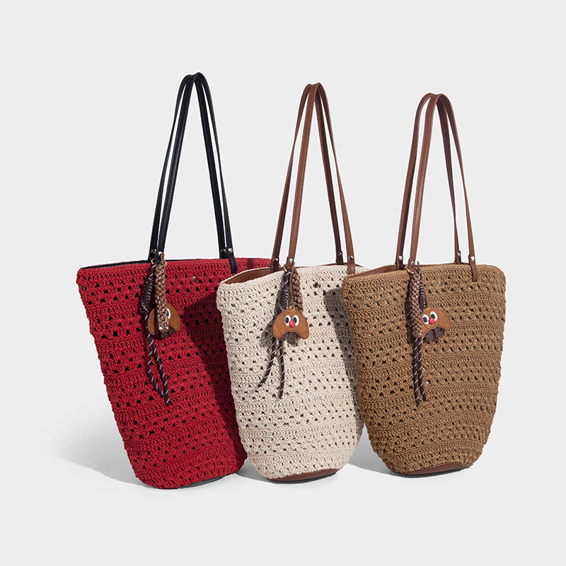 Open-weave crochet tote bag with brown leather-look shoulder straps and base trim, detail view 2