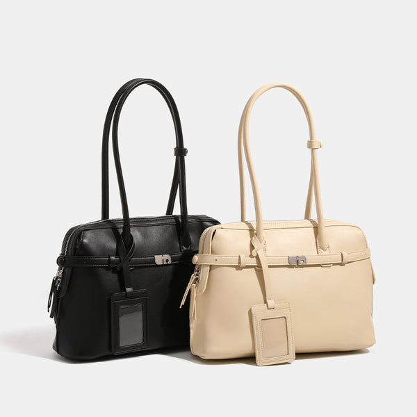 Structured leather-look zip-top tote satchel with twin handles, front turn-lock strap, hanging ID tag, and silver-tone