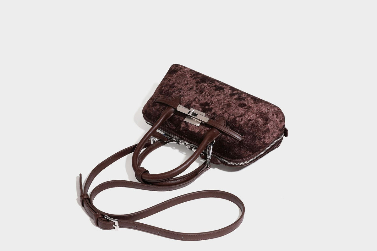 Small structured satchel bag in dark brown velvet-like textured finish with leather-look trim, silver-tone turn-lock bar