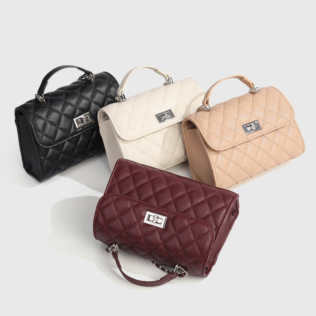 Small structured diamond-quilted flap satchel bag with silver-tone chain strap and turn-lock closure, detail view 2