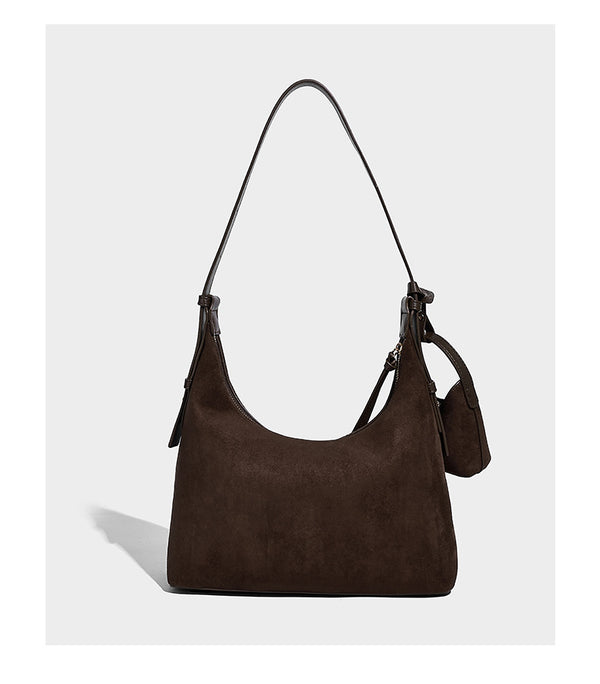 Dark brown suede-look hobo shoulder bag with top zip closure, adjustable strap, and small detachable mini pouch, detail view
