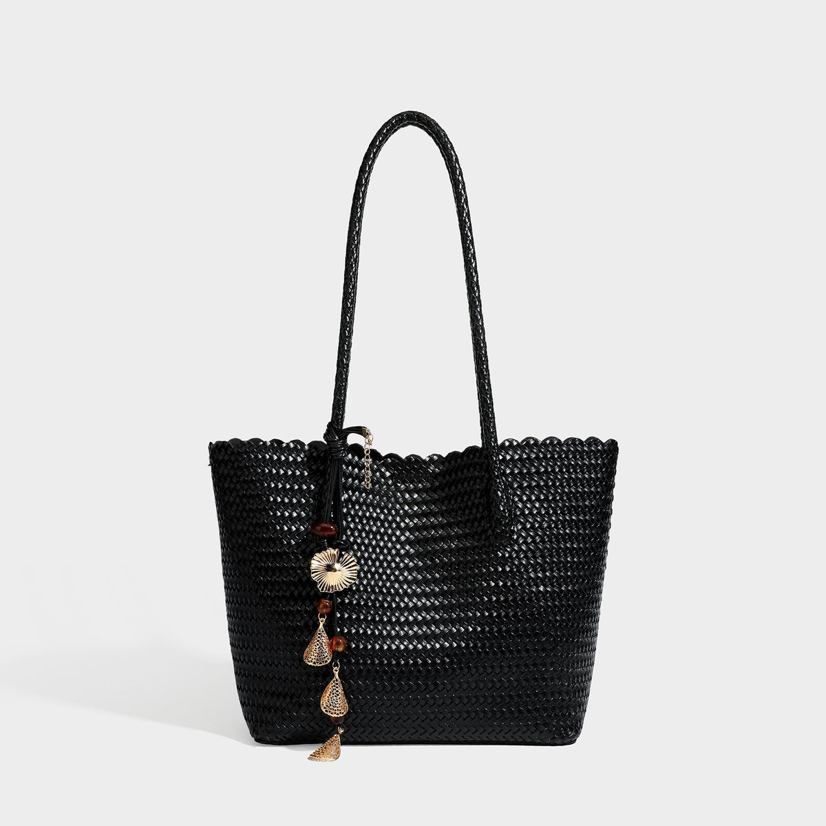 Large open-top woven leather-look tote bag in dark brown with scalloped edge, braided double shoulder straps, and decorative