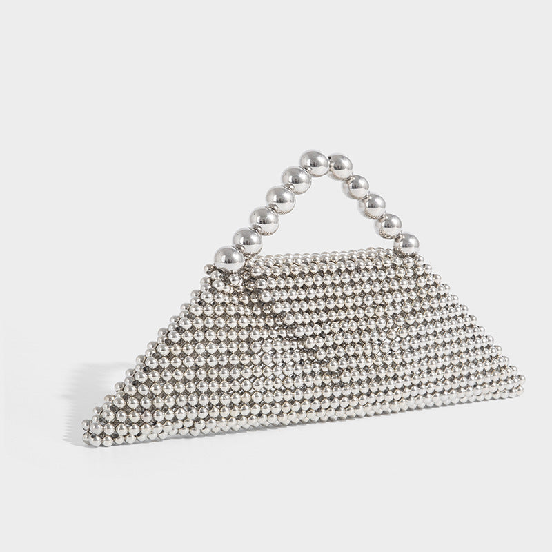 Small structured triangle clutch bag covered in glossy pearl beads with an arched pearl top handle and silver snap closure