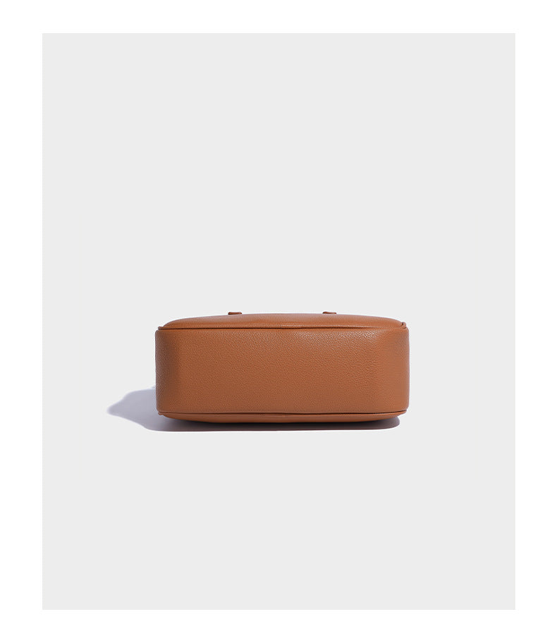 Structured pebbled leather-look Boston bowling bag in tan with blue detachable round mini pouch, dual top handles, and