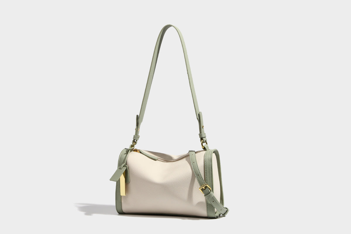Structured two-tone shoulder bag with pebbled leather-look finish, contrast trim, top zip closure, and gold-tone hardware