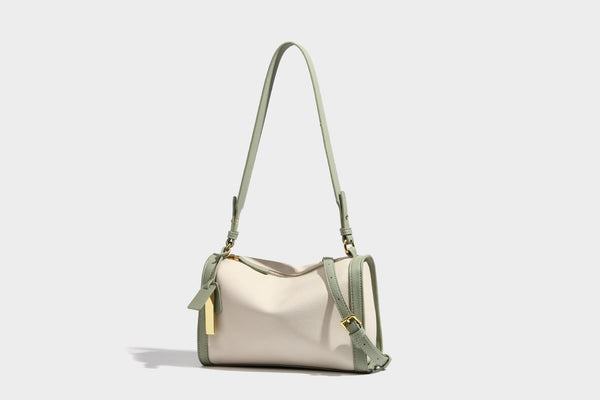 Structured two-tone shoulder bag with pebbled leather-look finish, contrast trim, top zip closure, and gold-tone hardware