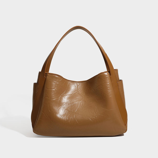 Black glossy crinkled leather-look convertible shoulder tote bag with gold gourd-shaped emblem hardware and detachable