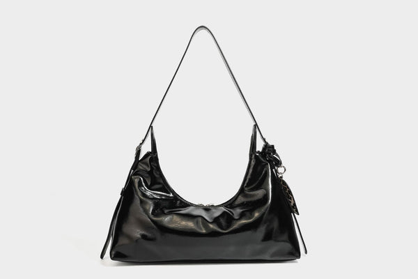 Glossy dark brown hobo shoulder bag with slim strap, front zip pocket, stud detail, and detachable leopard-print heart charm