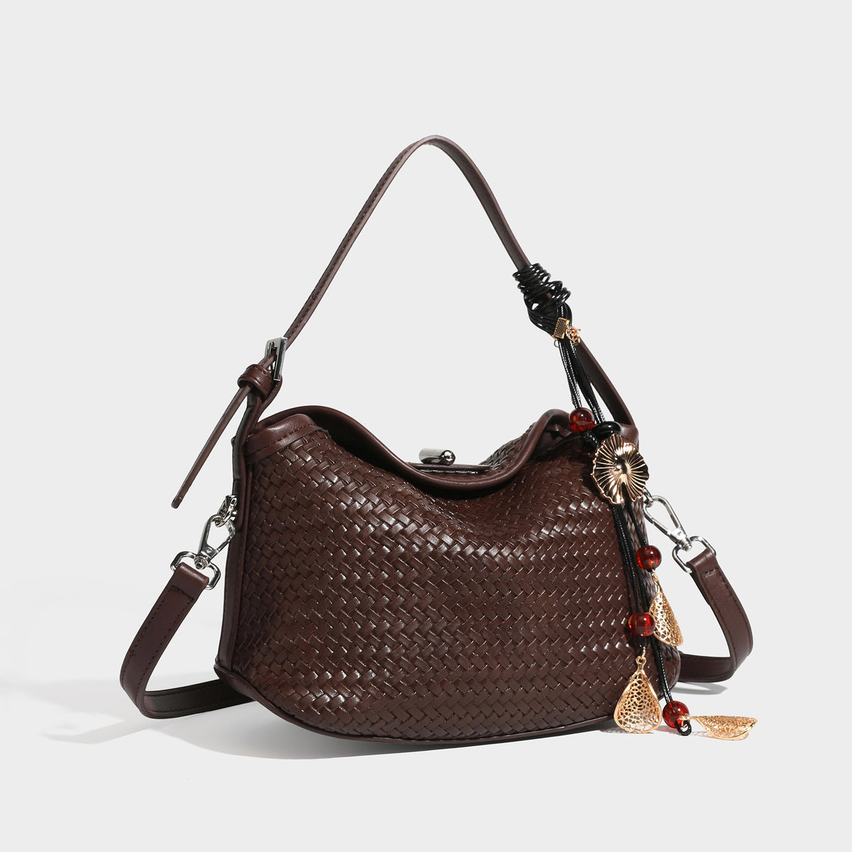 Small woven-look leather-look flap shoulder hobo bag in burgundy with silver-tone hardware and decorative tassel charm
