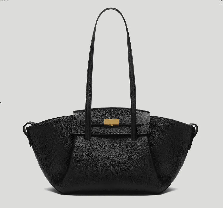 Black pebbled trapezoid tote bag with gold turn-lock hardware and double top handles, detail view 6