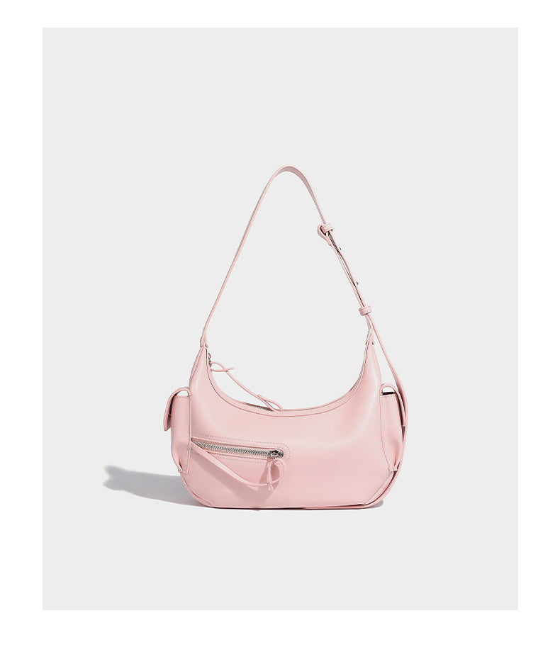 Smooth leather-look crescent shoulder bag with front zip pocket, side flap pockets, adjustable strap, and silver-tone, detail
